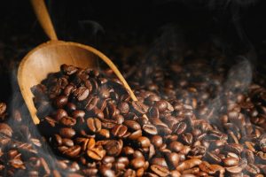 Wooden scoop over coffee beans